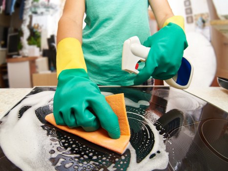 Natural oven cleaning supplies including baking soda and vinegar